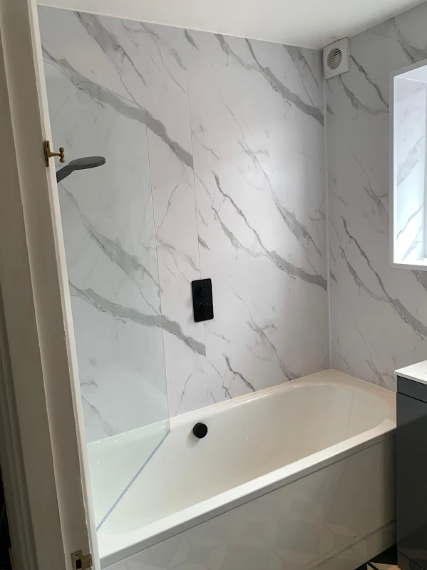 Marble effect panels and matt black fittings, one of our recent refits, by Beespoke Renovations